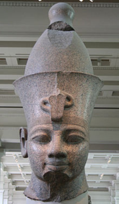 Head from monumental red granite statue of Amenhotep III || Photo Source: Wikipedia